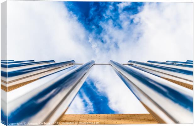 Fence with tall metal bars pointing to the blue sky with perspec Canvas Print by Joaquin Corbalan