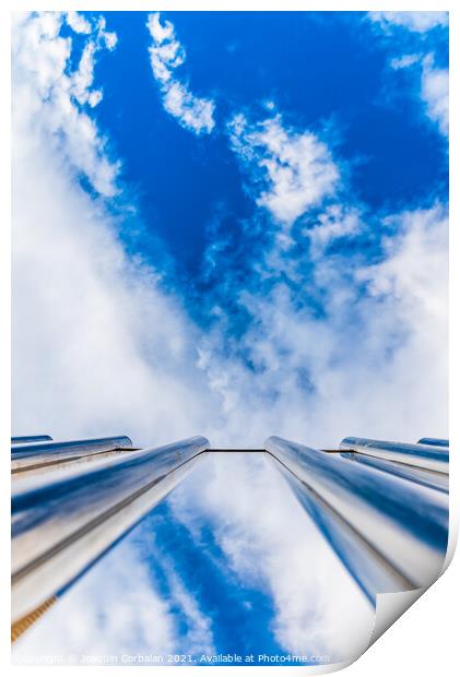 Fence with tall metal bars pointing to the blue sky with perspec Print by Joaquin Corbalan