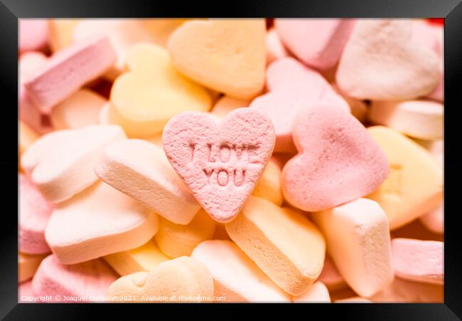 Love word engraved in a sweet romantic heart-shaped candy to giv Framed Print by Joaquin Corbalan