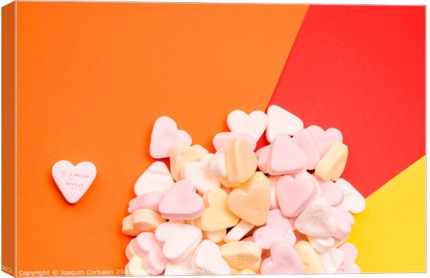 Word love in English on a candy heart, sweet image for Valentine Canvas Print by Joaquin Corbalan