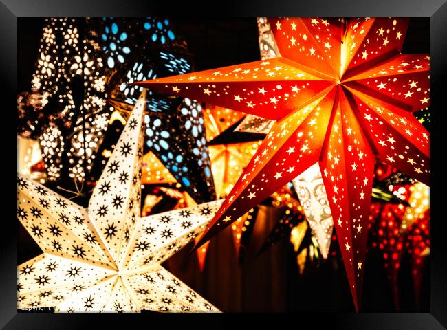Colourful Illuminated Christmas Star Decorations Framed Print by Peter Greenway