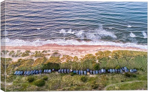 Beach huts nestled in the dunes - Brancaster beach Canvas Print by Gary Pearson