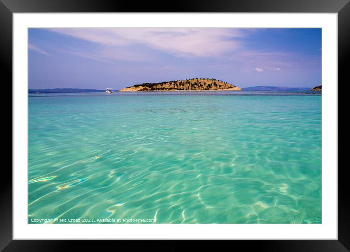 Island in a turquoise sea Framed Mounted Print by Nic Croad