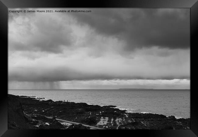 Fishermen at Westward Ho! watching the rain clouds coming in Framed Print by James Moore