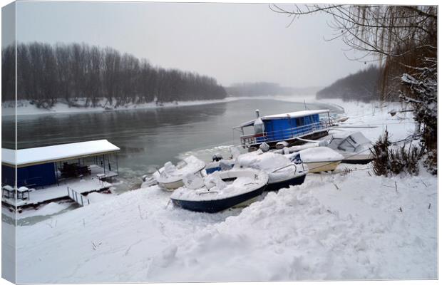 Boats under the snow on the river Borcea  Canvas Print by liviu iordache