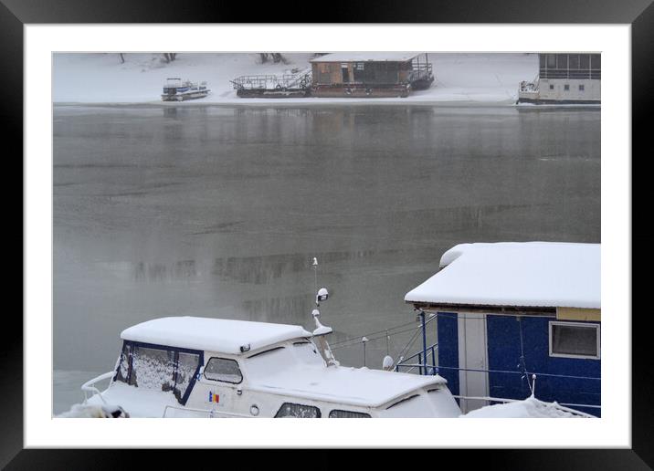 Boats under the snow on the river Borcea Framed Mounted Print by liviu iordache