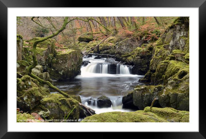 A small waterfall over a rocky cliff Framed Mounted Print by Barclay Brown