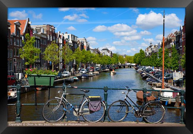 Bikes on the bridge that crosses the canal in Amsterdam, Netherlands Framed Print by Chun Ju Wu