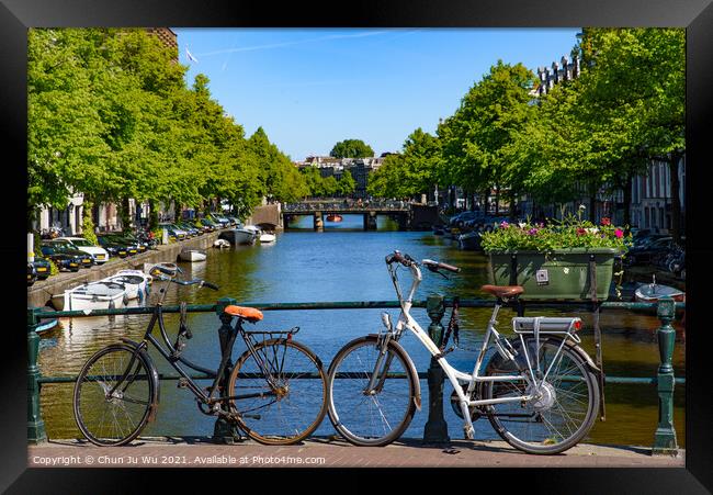 Bikes on the bridge that crosses the canal in Amsterdam, Netherlands Framed Print by Chun Ju Wu