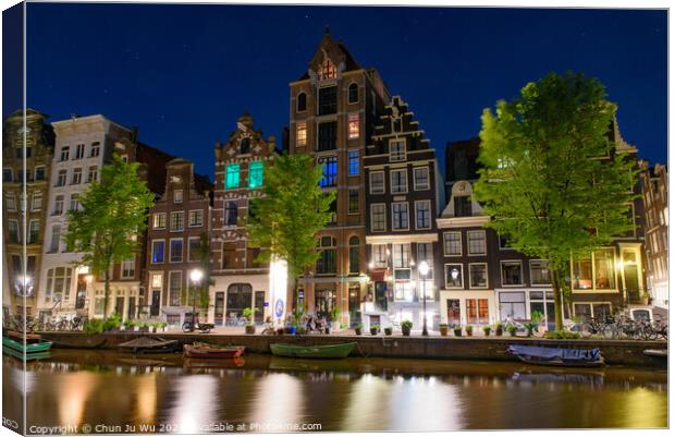 Night view of buildings and boats along the canal in Amsterdam, Netherlands Canvas Print by Chun Ju Wu