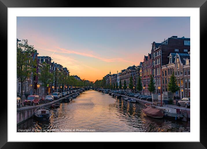Buildings and boats along the canal at sunset time in Amsterdam, Netherlands Framed Mounted Print by Chun Ju Wu