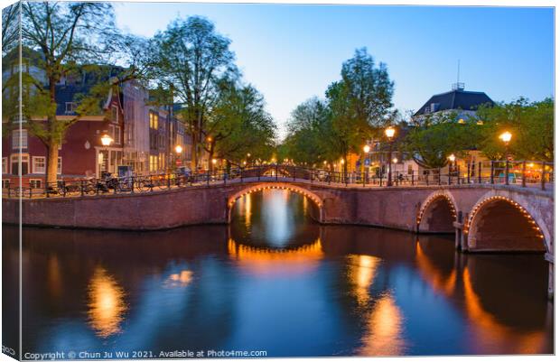 Reflection of bridge along the canal at night in Amsterdam, Netherlands Canvas Print by Chun Ju Wu
