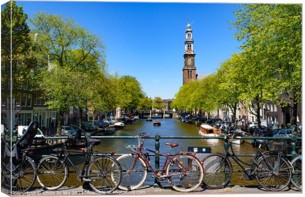 Bikes on the bridge that crosses the canal in Amsterdam, Netherlands Canvas Print by Chun Ju Wu