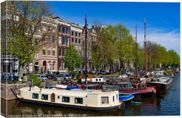 Buildings and boats along the canal in Amsterdam, Netherlands Canvas Print by Chun Ju Wu