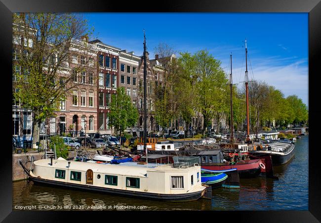 Buildings and boats along the canal in Amsterdam, Netherlands Framed Print by Chun Ju Wu