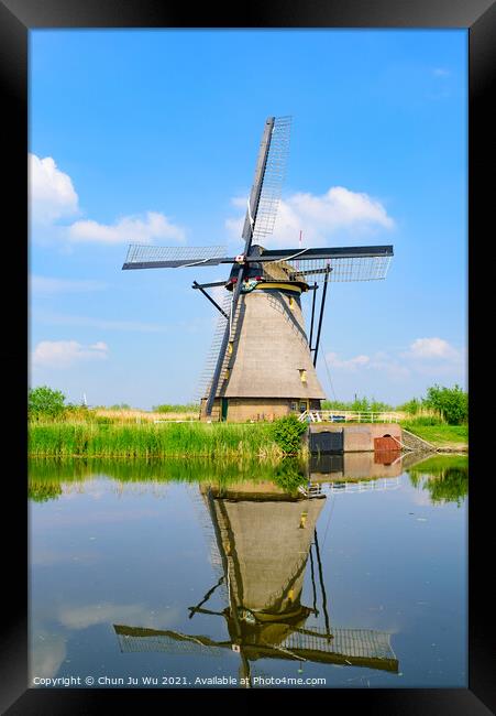 The windmills and the reflection on water in Kinderdijk, a UNESCO World Heritage site in Rotterdam, Netherlands Framed Print by Chun Ju Wu