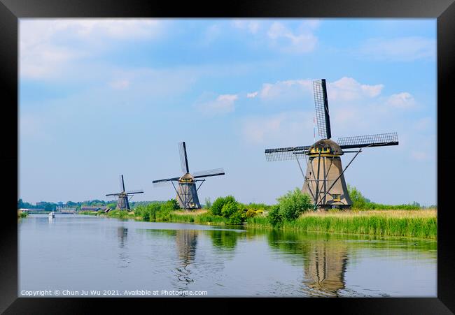 The windmills and the reflection on water in Kinderdijk, a UNESCO World Heritage site in Rotterdam, Netherlands Framed Print by Chun Ju Wu