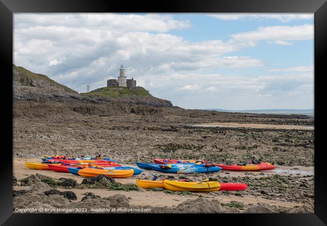 Mumbles lighthouse with Kayaks in foreground at the Bracelet bay Framed Print by Bryn Morgan
