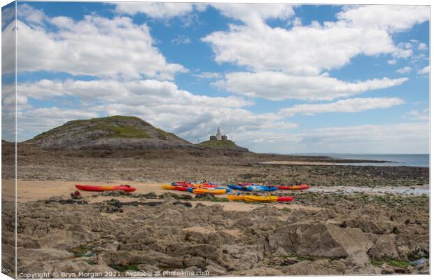 Mumbles lighthouse with Kayaks in foreground at the Bracelet bay Canvas Print by Bryn Morgan