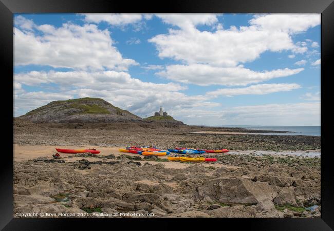 Mumbles lighthouse with Kayaks in foreground at the Bracelet bay Framed Print by Bryn Morgan