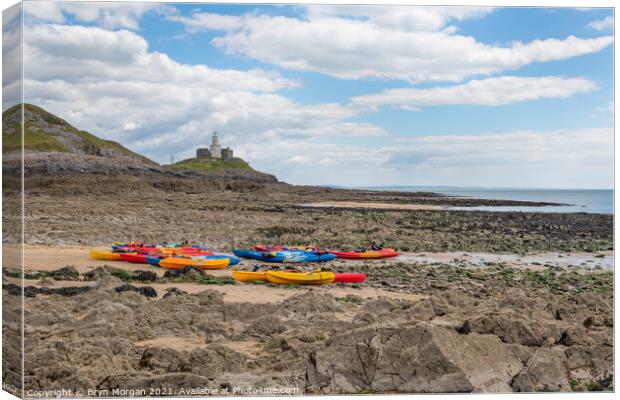 Mumbles lighthouse with Kayaks in foreground at the Bracelet bay Canvas Print by Bryn Morgan