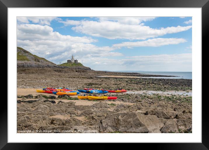 Mumbles lighthouse with Kayaks in foreground at the Bracelet bay Framed Mounted Print by Bryn Morgan