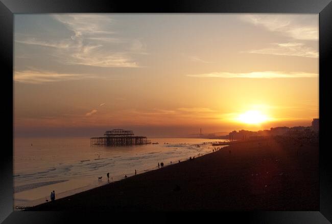 Setting sun and West Pier at Brighton, Sussex, UK. Framed Print by Peter Bolton