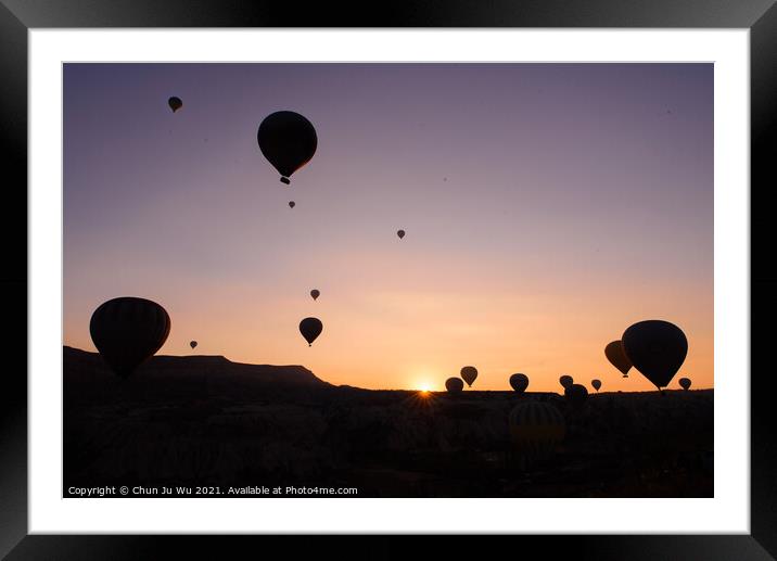 Silhouette of flying hot air balloons and rock landscape at sunrise time in Goreme, Cappadocia, Turkey Framed Mounted Print by Chun Ju Wu