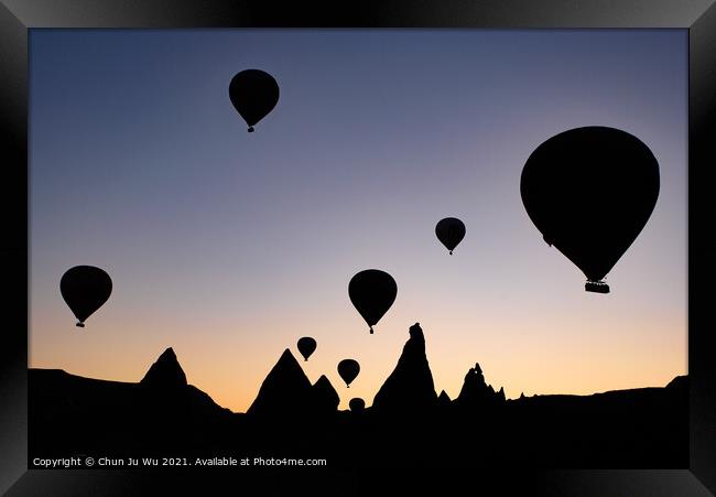 Silhouette of flying hot air balloons and rock landscape at sunrise time in Goreme, Cappadocia, Turkey Framed Print by Chun Ju Wu