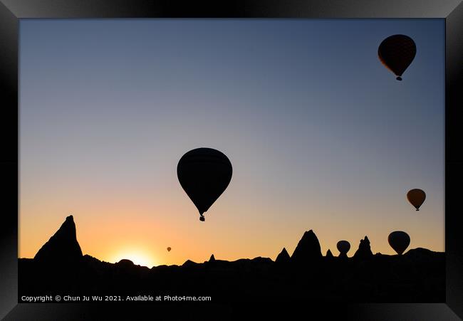 Silhouette of flying hot air balloons and rock landscape at sunrise time in Goreme, Cappadocia, Turkey Framed Print by Chun Ju Wu