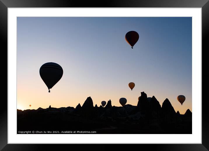 Silhouette of flying hot air balloons and rock landscape at sunrise time in Goreme, Cappadocia, Turkey Framed Mounted Print by Chun Ju Wu