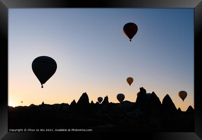 Silhouette of flying hot air balloons and rock landscape at sunrise time in Goreme, Cappadocia, Turkey Framed Print by Chun Ju Wu