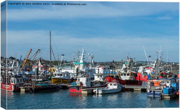 A Busy Newlyn Harbour with fishing boats moored up Canvas Print by Nick Jenkins