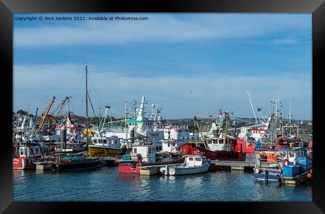 A Busy Newlyn Harbour with fishing boats moored up Framed Print by Nick Jenkins