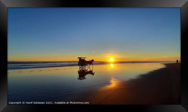 Silhouetted horse-drawn carriage beach sunset 4 Framed Print by Hanif Setiawan