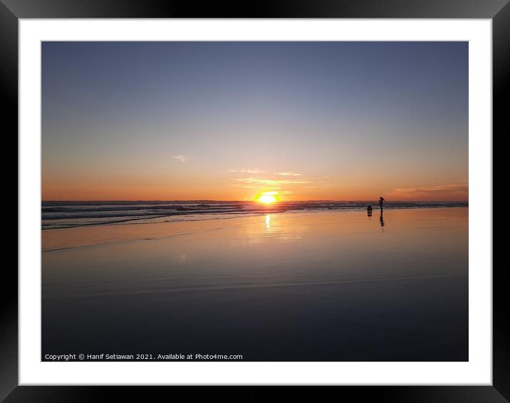 Silhouetted couple enjoys sunset at beach 2 Framed Mounted Print by Hanif Setiawan