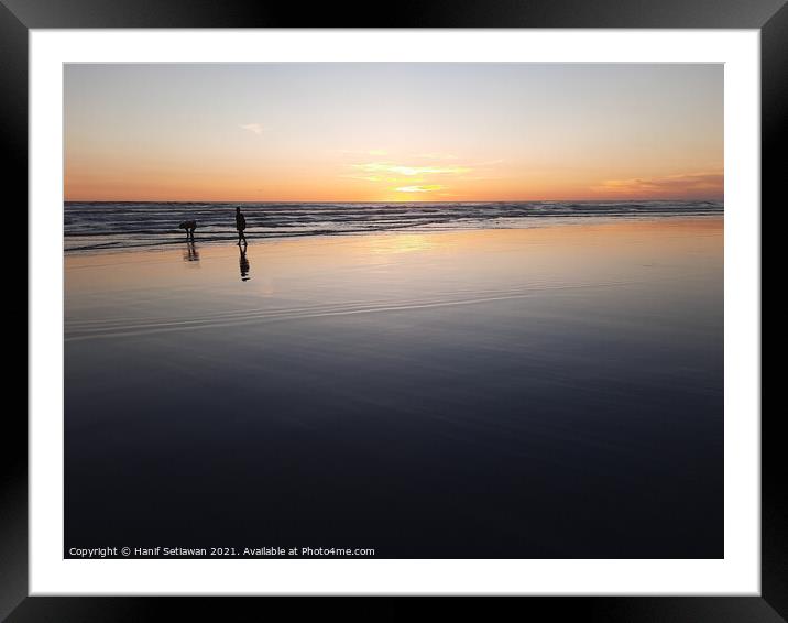Silhouetted couple enjoys sunset at beach 3 Framed Mounted Print by Hanif Setiawan