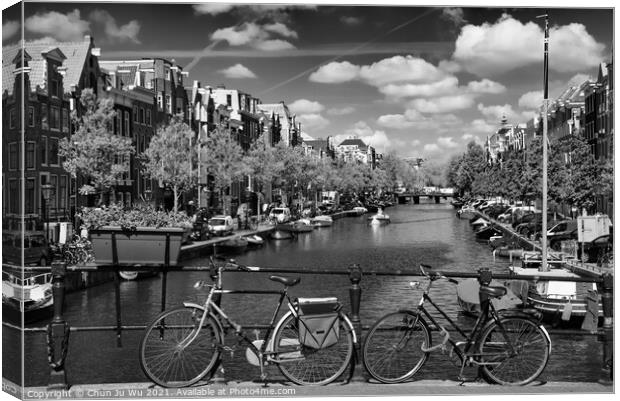 Bikes on the bridge that crosses the canal in Amsterdam (black & white) Canvas Print by Chun Ju Wu