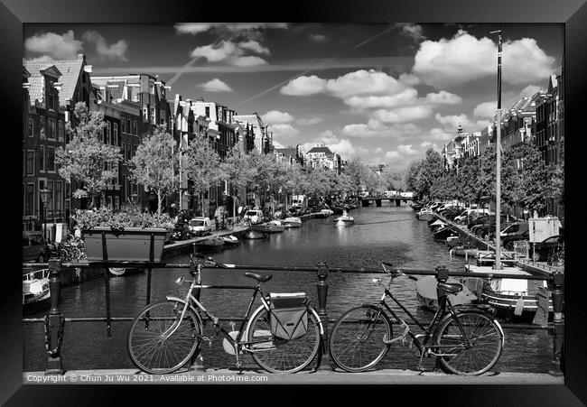 Bikes on the bridge that crosses the canal in Amsterdam (black & white) Framed Print by Chun Ju Wu
