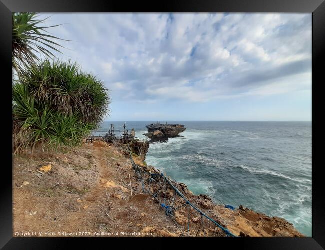 A rock plateau and a rock island in the sea Framed Print by Hanif Setiawan