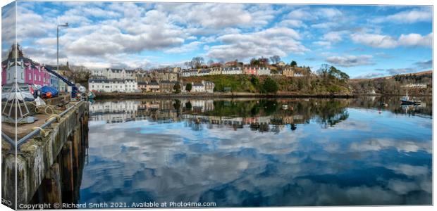 The town of Portree surrounds the harbour with reflections of the sky. Canvas Print by Richard Smith