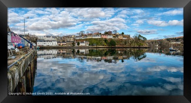 The town of Portree surrounds the harbour with reflections of the sky. Framed Print by Richard Smith
