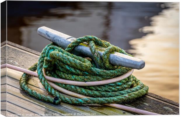 Rope tied around a metal bollard mooring on a wooden jetty Canvas Print by SnapT Photography