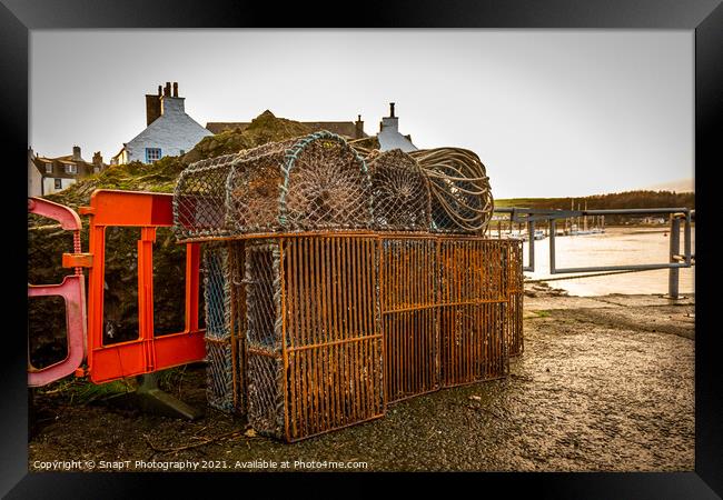 Lobster and prawn fishing pots and creels stacked up at Kirkcudbright Harbour Framed Print by SnapT Photography