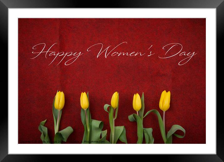 happy womens day text on yellow tulips on red background. greeting card concept. sensual tender women's image. spring flowers in soft morning sunlight flat lay Framed Mounted Print by Emils Vanags