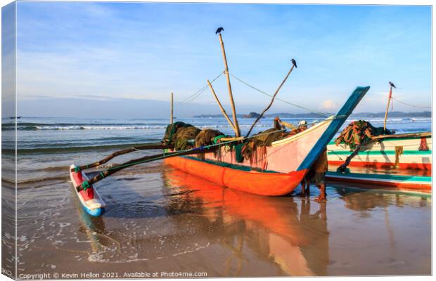 Traditional fishing boat on beach Canvas Print by Kevin Hellon