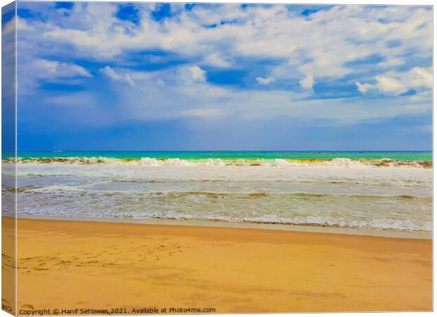Sand beach wavy sea and cloud sky 1b Canvas Print by Hanif Setiawan