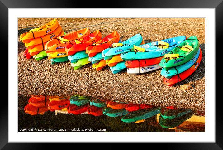 Kayaks by a Lake Framed Mounted Print by Lesley Pegrum