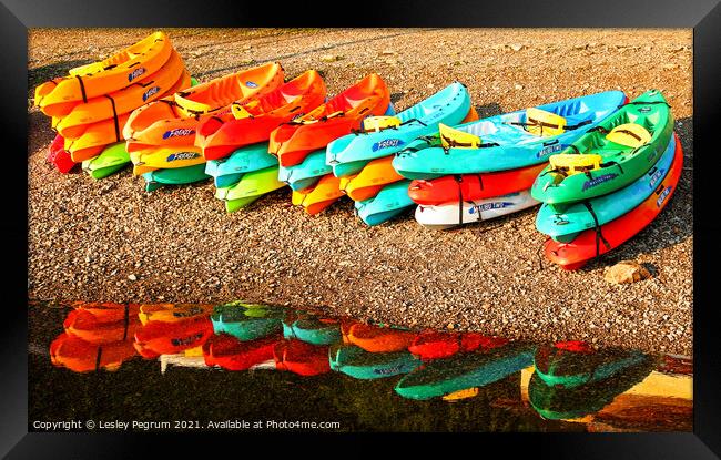 Kayaks by a Lake Framed Print by Lesley Pegrum