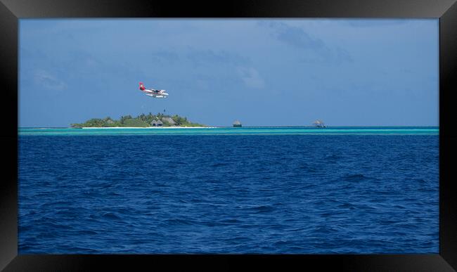 Maldives Islands with sea plane landing Framed Print by mark humpage